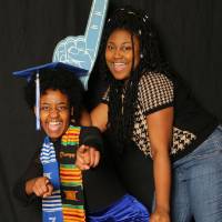 two students take a funny picture at the photo booth